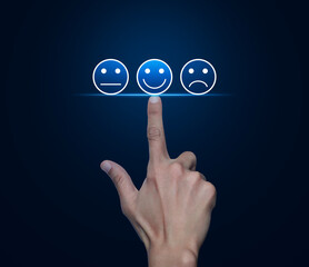 Hand pressing excellent smiley face rating icon over light blue background, Business customer service evaluation and feedback rating concept