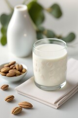 Glass with vegan almond milk with almonds on a white table.Generative AI