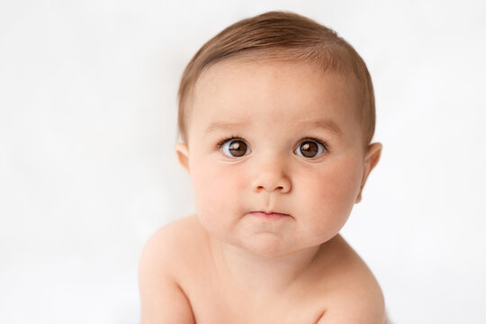Close-up portrait of funny baby with surprised expression