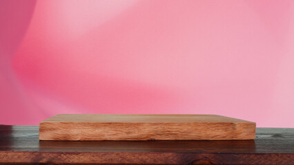 Blank wooden board on light pink fabric background on a clean background