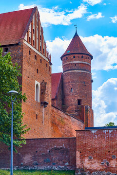 Olsztyn, Poland, August 10, 2022. Castle of Warmian Chapter, photo from north, northwest pediment and lavatory. castle was erected in naturally defensive place, on hill in wide bend of Lyna River.
