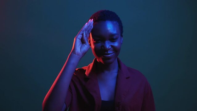 Respect salute. Honor greeting. Yes sir. National pride. Red blue neon color light proud patriot woman formal hand gesture isolated on dark night gif loop boomerang animation.