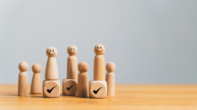 Wooden model of a human figure with a right check sign, representing human resource management concepts such as talent management, recruitment, and retention