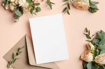 Wedding invitation or greeting card mockup with fresh roses flowers and envelope, blank card with copy space
