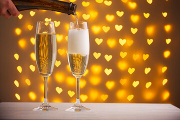 beautiful glasses of champagne on a blurred background of hearts