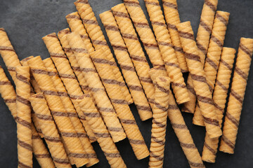 Close-up of striped wafer rolls. Background or texture