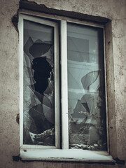 A broken window and an open frame in a residential building