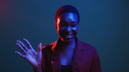 Hello gesture. Welcome greeting. Meeting acquaintance. Red blue neon color light friendly cheerful smiling woman waving hi isolated on dark night gif loop boomerang animation.