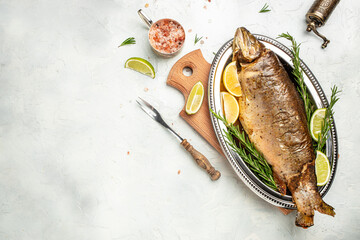 Grilled fish with lemon herbs and spices on a light background, banner, menu, recipe place for text, top view