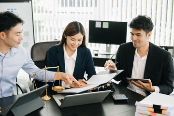 Asian business team and lawyers discussing contract papers sitting at the table. Concepts of law, advice, legal services. at office