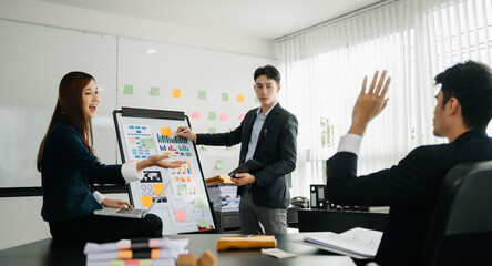 The boss stands near the board with graphs, demonstrates statistics, various personnel attending the training, introduces the new products of the company, in office.