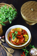 Kepiting Saos Padang or Indonesian Spicy crabs, served with shrimp and corn. Selective focus on dark wooden background.