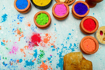 top view of colorful traditional holi powder in bowls isolated on dark background.Space for text . happy holi.Concept Indian color festival called Holi