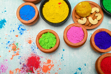 top view of colorful traditional holi powder in bowls isolated on dark background.Space for text . happy holi.Concept Indian color festival called Holi