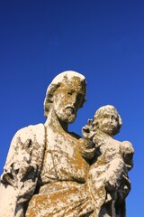 Saint Joseph holding the baby Jesus.