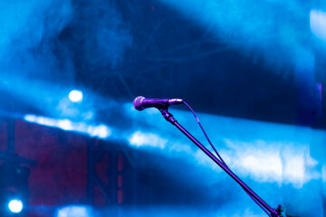 Microphones prepared for the concert in the dark stage shows, dark blue background, an empty dark scene.