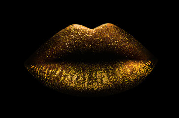 Beautiful lips with shiny golden lipstick on black background