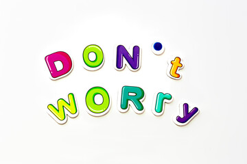 Colorful funy lettering fridge magnets with 'Don't worry' lettering on isolated white background.