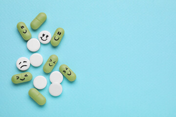 Different antidepressants with emoticons on light blue background, flat lay. Space for text