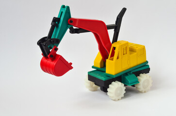 A plastic toy excavator that is 30 years old