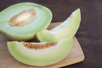 Cut tasty ripe melon on wooden table