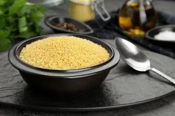 Raw couscous and ingredients on grey table, closeup