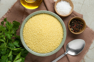 Raw couscous and ingredients on light table, flat lay
