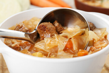 Tasty cabbage soup with meat and carrot, closeup