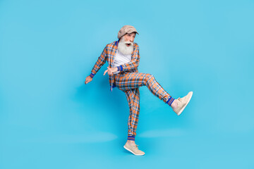 Full length photo of cheerful carefree gentleman music lover wear plaid trendy suit dancing nightclub isolated on blue color background