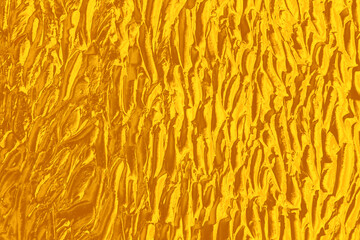 Strokes of golden paint as background, closeup