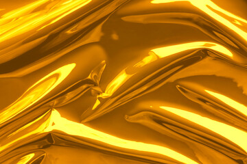 Shiny crumpled golden foil as background, closeup
