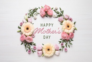 Happy Mother's Day. Greeting card with frame of beautiful flowers on white wooden background, flat lay - obrazy, fototapety, plakaty