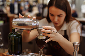 Two baristas work on creating coffee in a coffee shop