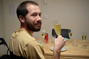 Young caucasian man drinking champagne 