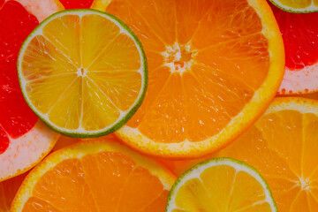 Top view: colorful fresh citrus fruits slices - orange, grapefruit and lime - close up. Tropical, natural, exotic, summer and healthy food concept