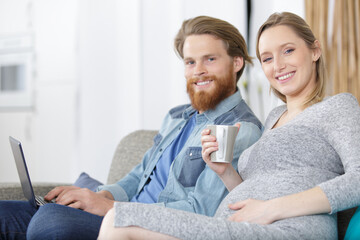 pregnant woman and her husband using a pc