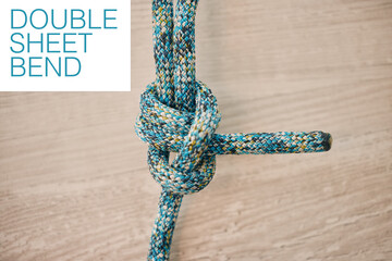 Rope climbing for mountain rock hiking, strong secure safety knot tie and closeup zoom on wood...