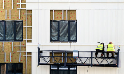 Repair of wall of facade of house with mineral insulation and panels. Heat saving concept.