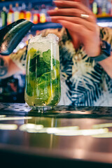man hand bartender making cocktail in glass on the bar counter