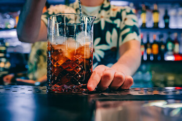 man hand bartender making cocktail in glass on the bar counter