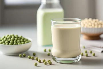 Zelfklevend Fotobehang Glass with vegan pea protein milk on a white table.  © Anna