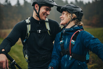 Young couple smiling after a mountain bike ride together