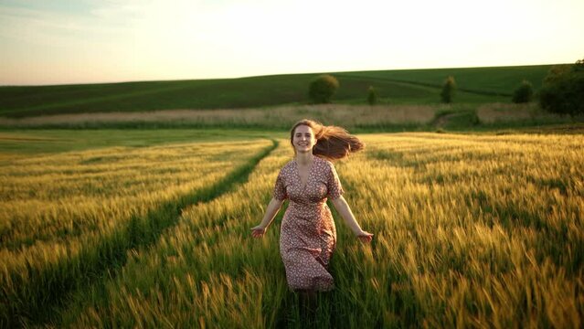 free girl running fun through wheat field, agriculture, children's dream concept.  farmer girl, happy young beautiful pretty woman running in the field, long hair fluttering