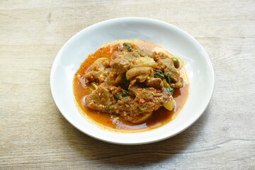 spicy stir fried slice pork leg with eggplant curry on plate