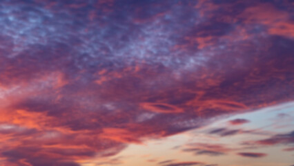Sunset sky. Cirrocumulus and cirrostratus clouds during sunset. Beautiful dramatic sunset sky background. Selective focus included. Noisy photo.