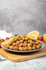 Scratched green olives. Brined scratched green olives on a wood serving board. low angle view