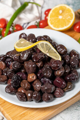 Black olive. Olives on a wooden serving board. close up