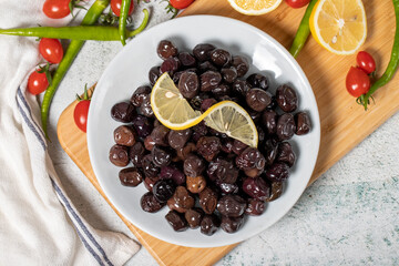 Black olive. Olives on a wooden serving board. Top view