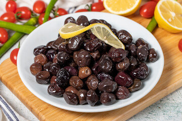 Black olive. Olives on a wooden serving board. close up