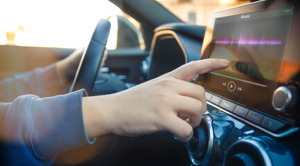 Teenager using touch screen while driving a car. Security, technology, communication concept.